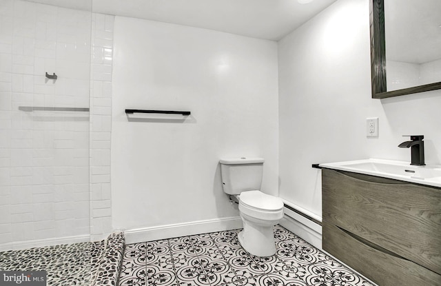 bathroom featuring vanity, a baseboard heating unit, tile patterned flooring, toilet, and tiled shower