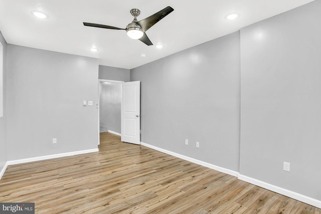 spare room featuring light hardwood / wood-style floors and ceiling fan