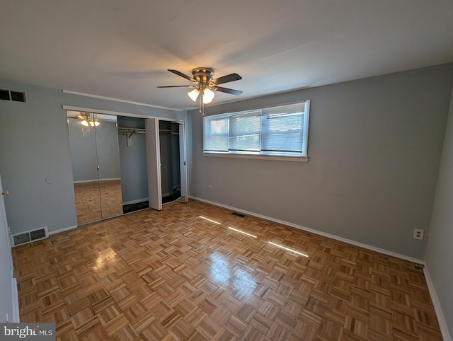 unfurnished bedroom featuring ceiling fan and parquet flooring