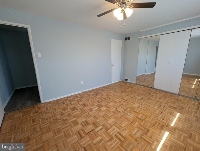 unfurnished bedroom with ceiling fan and light parquet flooring