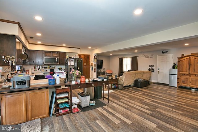 kitchen featuring dark brown cabinets, stainless steel appliances, and dark hardwood / wood-style floors