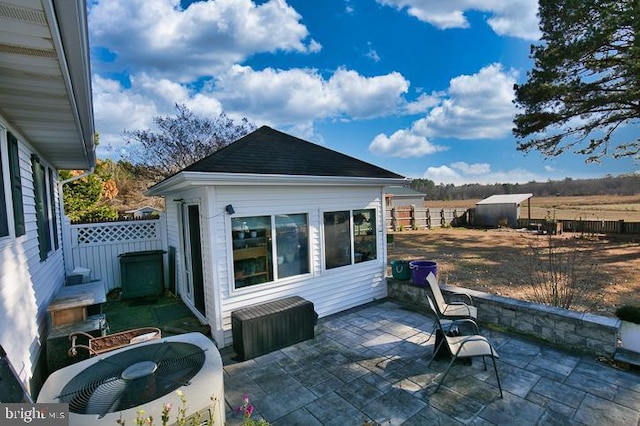 view of patio with a shed and cooling unit