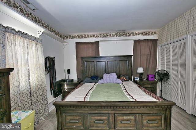 bedroom with a closet and light hardwood / wood-style floors