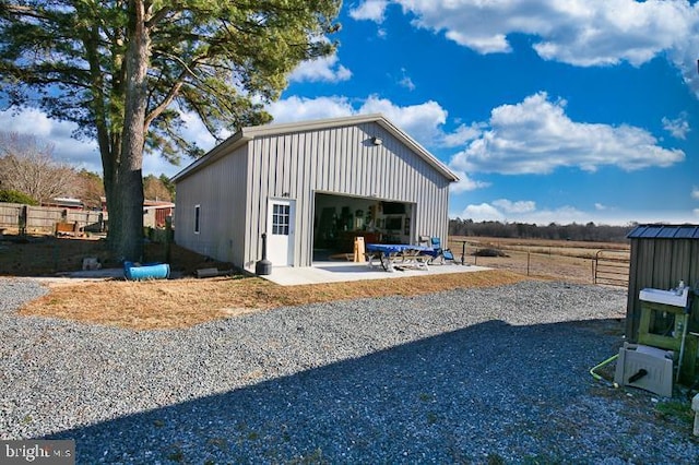 exterior space with a rural view and a garage