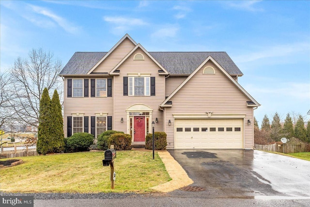 view of front of house featuring a garage and a front lawn