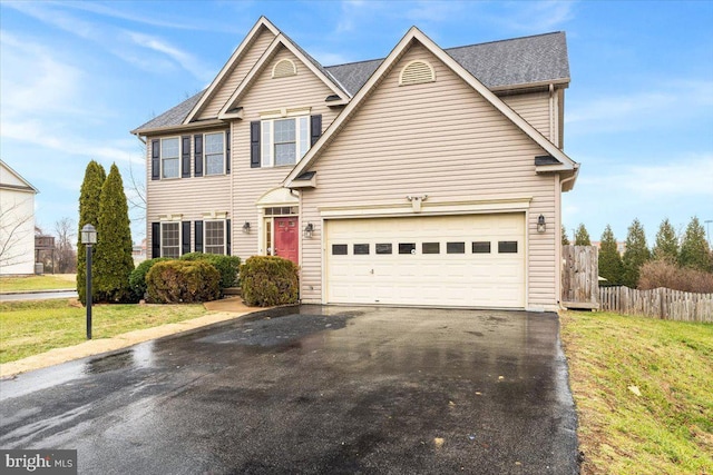 view of front of property featuring a front lawn and a garage