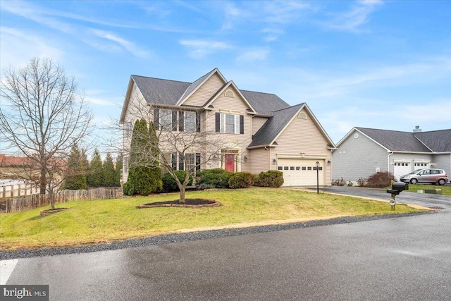 view of front of home featuring a front yard and a garage