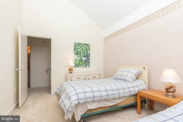 bedroom with light colored carpet and high vaulted ceiling