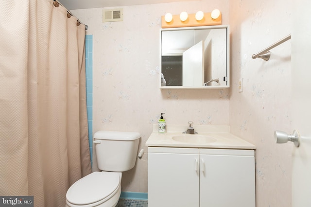 bathroom featuring a shower with shower curtain, vanity, and toilet