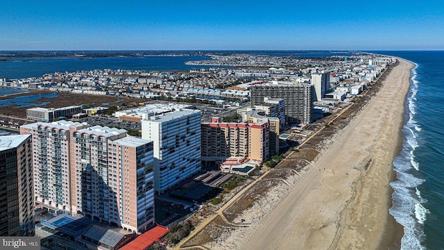 drone / aerial view featuring a view of the beach and a water view