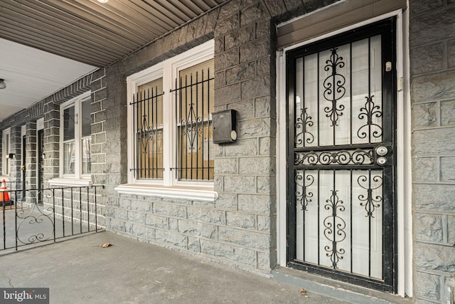 view of exterior entry with covered porch