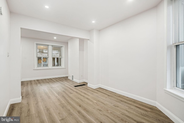 empty room with light hardwood / wood-style flooring