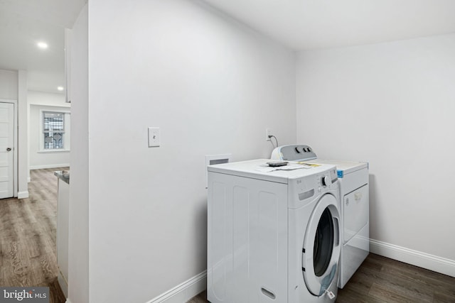 laundry room featuring hardwood / wood-style flooring and washing machine and clothes dryer