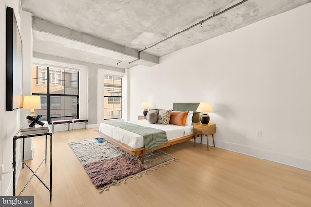 bedroom with wood finished floors and baseboards