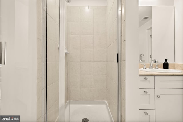 bathroom featuring vanity, visible vents, and a stall shower