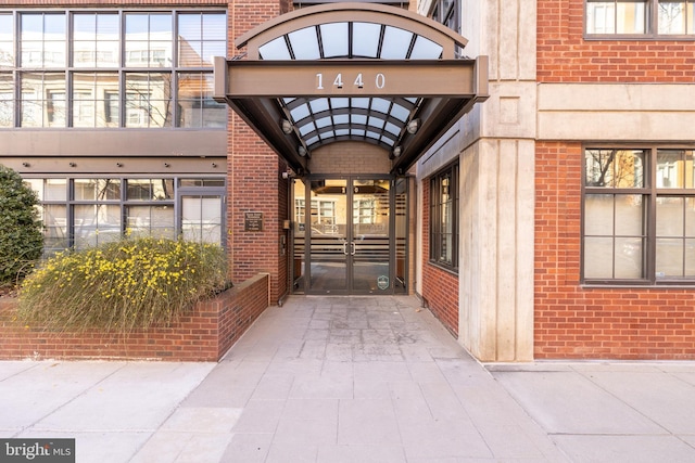 entrance to property featuring brick siding