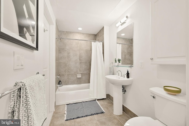 bathroom featuring tile patterned floors, shower / bath combination with curtain, toilet, and baseboards