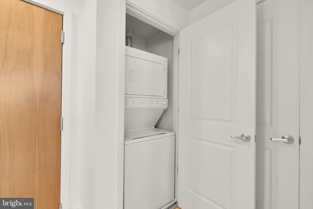 laundry room with laundry area and stacked washer / dryer