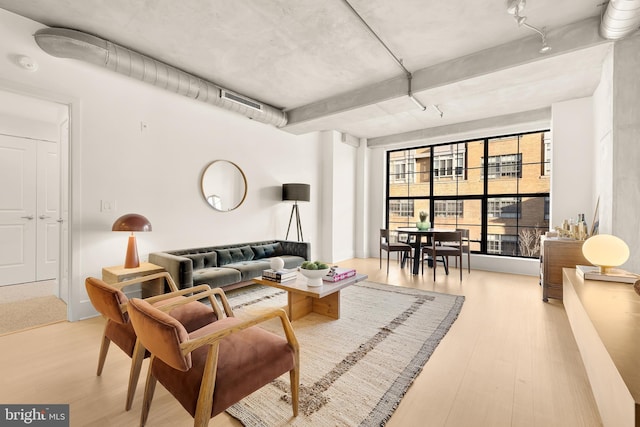 living area with wood finished floors and visible vents