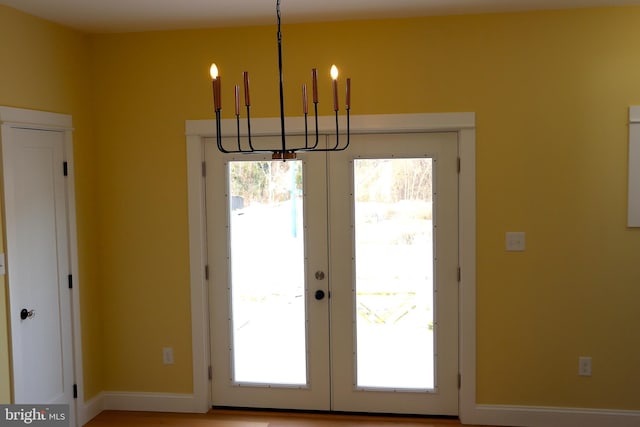 doorway featuring french doors and a chandelier