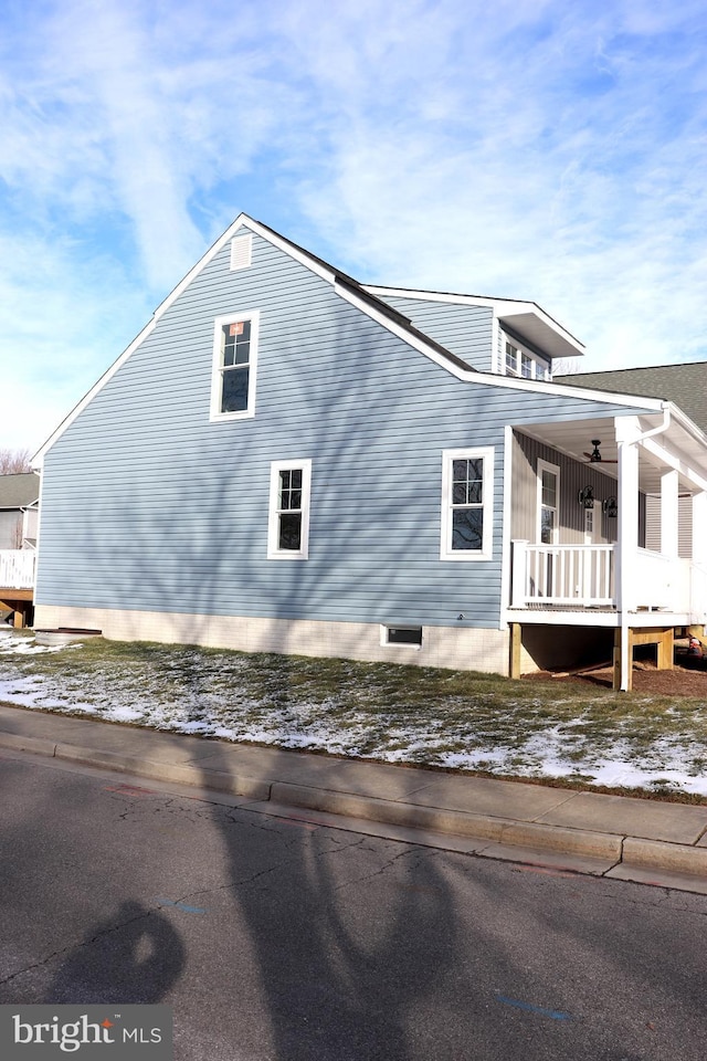 snow covered property featuring a porch