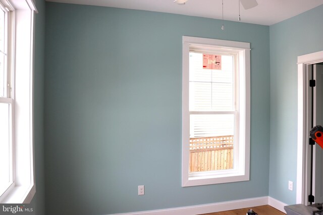 spare room with wood-type flooring and ceiling fan