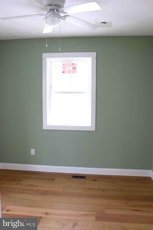 spare room featuring ceiling fan and light hardwood / wood-style flooring