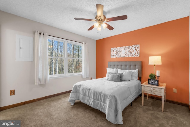 bedroom with carpet flooring, electric panel, ceiling fan, and a textured ceiling