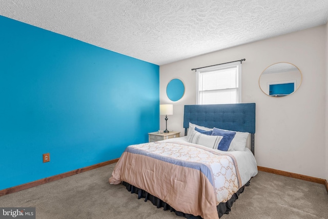 bedroom featuring light carpet and a textured ceiling