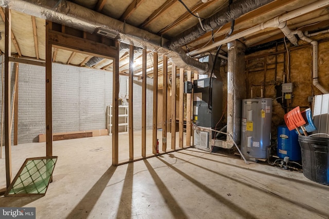 basement featuring heating unit and water heater