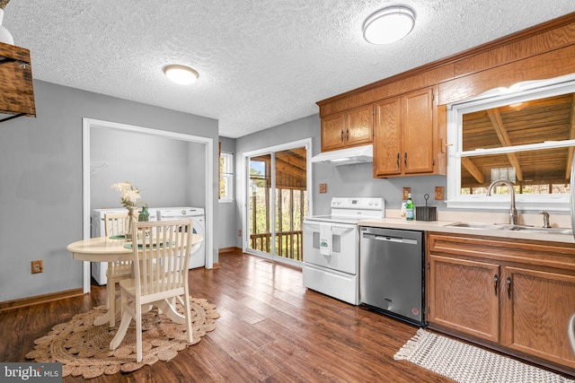 kitchen with dishwasher, sink, dark hardwood / wood-style flooring, washer / clothes dryer, and stove