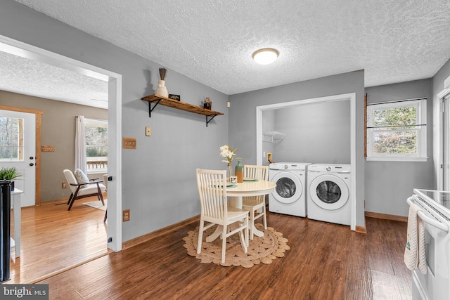 laundry room featuring a textured ceiling, dark hardwood / wood-style flooring, and a healthy amount of sunlight