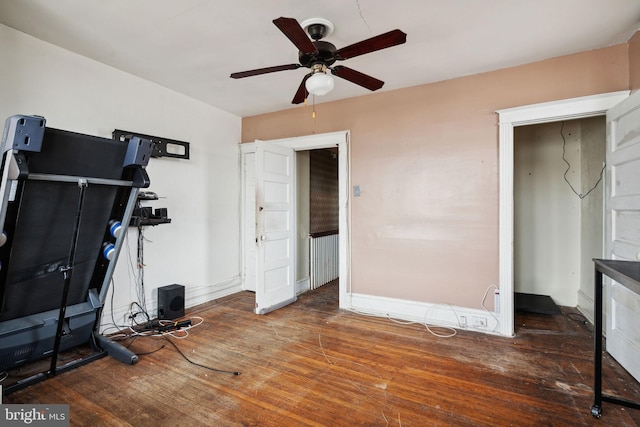 exercise area with ceiling fan and dark hardwood / wood-style flooring