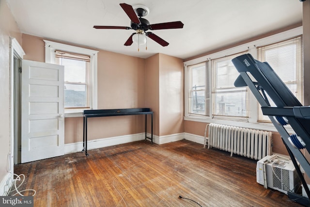 miscellaneous room with ceiling fan, dark wood-type flooring, and radiator heating unit