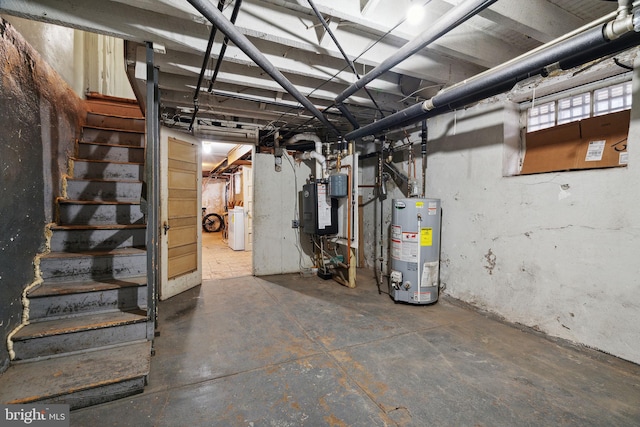 basement with gas water heater and washer / dryer