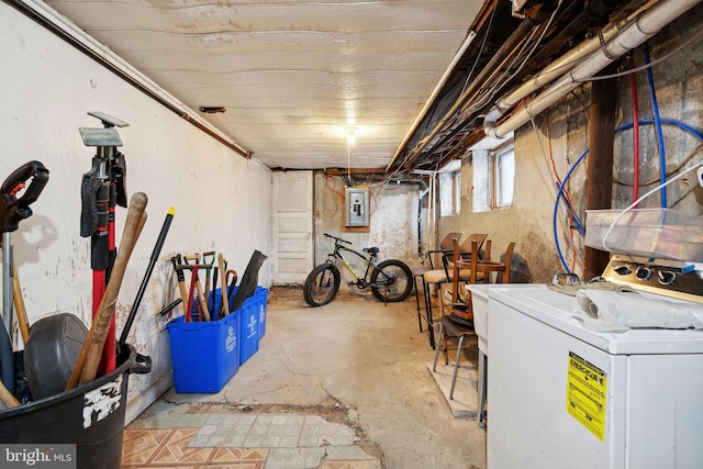 basement featuring electric panel and washer / dryer