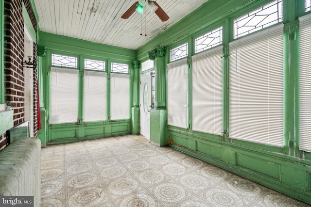 unfurnished sunroom featuring plenty of natural light and ceiling fan