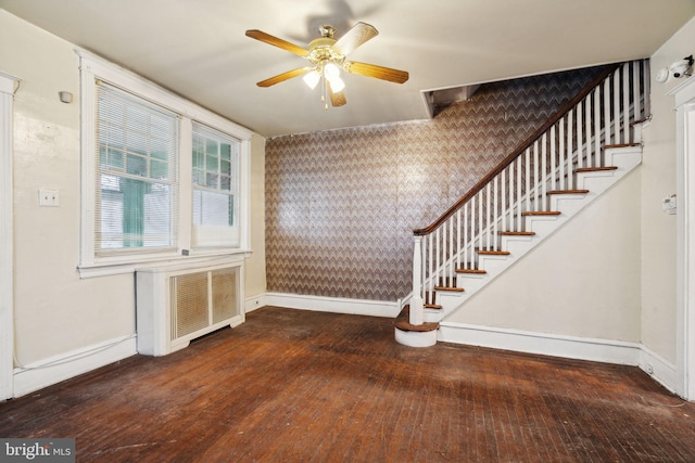 entrance foyer with ceiling fan, dark hardwood / wood-style floors, and radiator heating unit