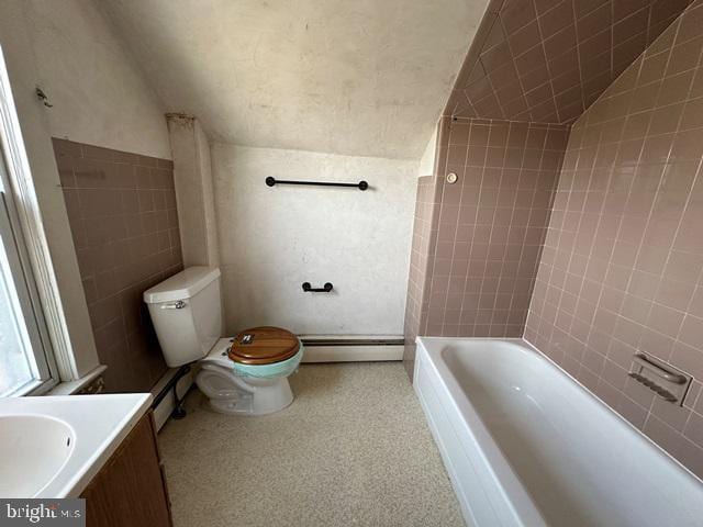 full bathroom featuring vanity, a baseboard radiator, toilet, and lofted ceiling