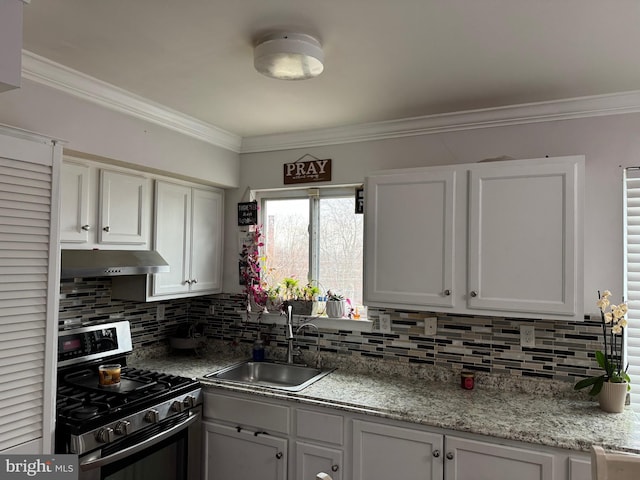 kitchen with decorative backsplash, white cabinetry, stainless steel range with gas cooktop, and sink