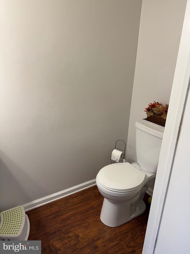 bathroom featuring toilet and wood-type flooring