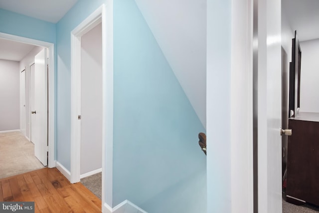 hallway with light hardwood / wood-style floors