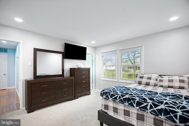 bedroom featuring light carpet