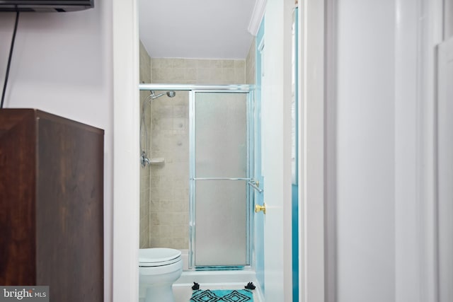 bathroom featuring toilet and walk in shower