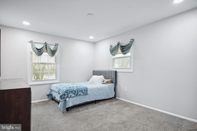 carpeted bedroom with multiple windows