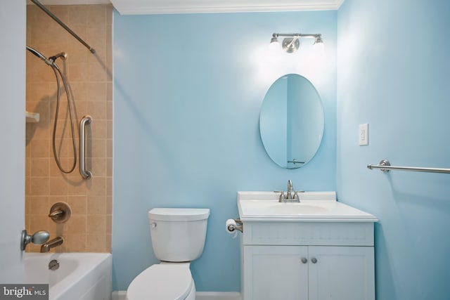 full bathroom with vanity, toilet, ornamental molding, and tiled shower / bath combo