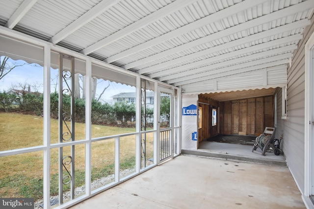 unfurnished sunroom with lofted ceiling