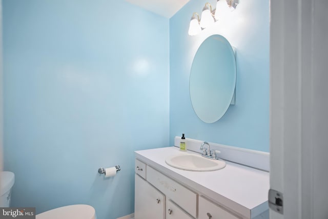 bathroom featuring vanity and toilet