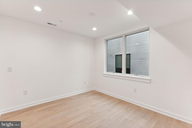 empty room with light hardwood / wood-style flooring