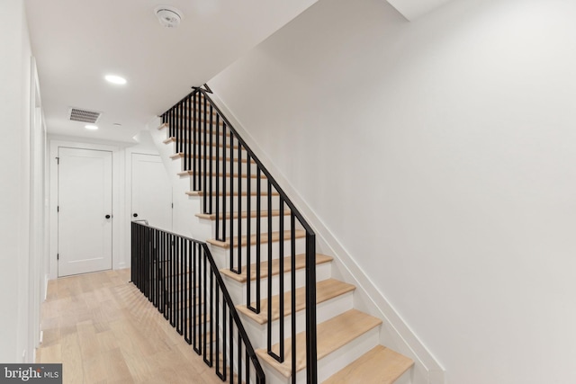 staircase featuring wood-type flooring